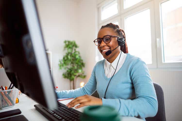 Customer support specialist working at her office