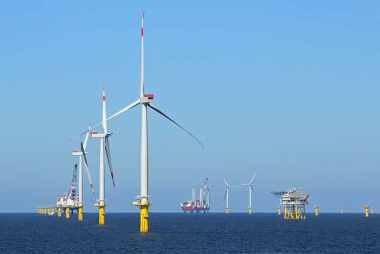 Industrial stations, wind turbines, and fuel stations in the middle of the ocean
