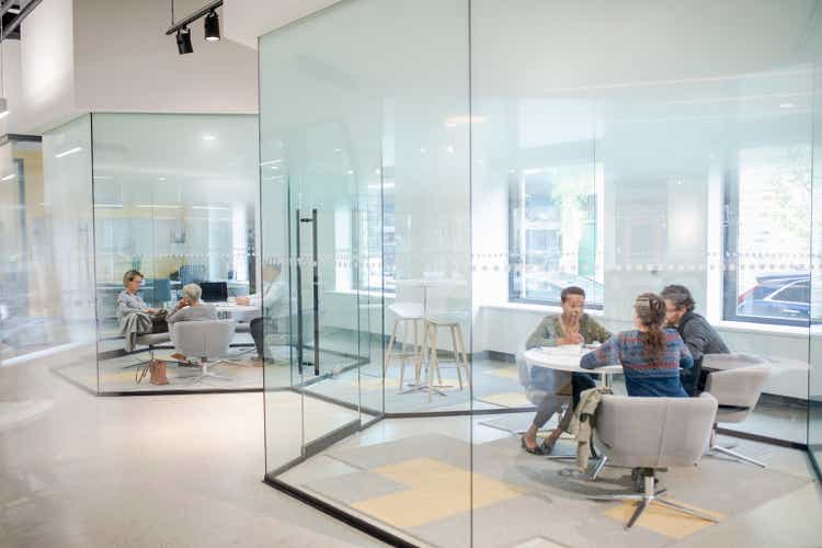 Loan managers working with clients in bank branch offices