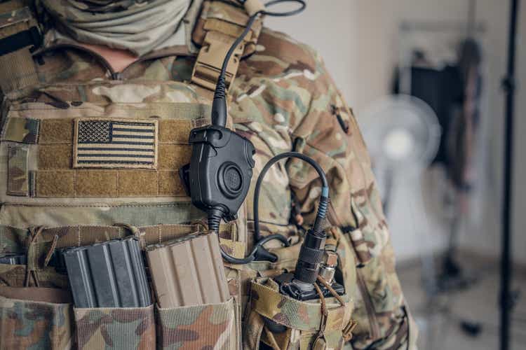 Military man with radio in pocket