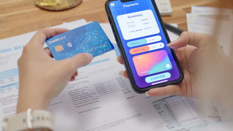 Close up hands woman use smartphone paying with contactless payment and banking app pay online utility bill payment with credit card internet banking technology and money transfer.