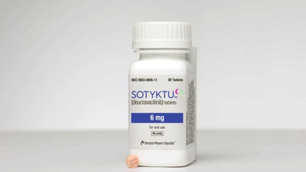 An image of a pill bottle next to a tablet of Sotyktu, a psoriasis medicine from Bristol Myers Squibb.