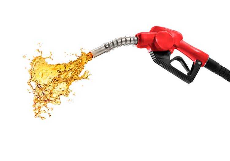 Petrol splashing out of pistol, isolated on white background