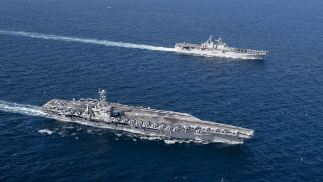 The Amphibious Assault Ship USS Essex (top) and USS John Stennis Aircraft Carrier in the Arabian Sea