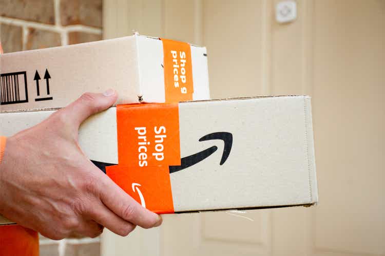 Коробки Amazon Prime доставляются к входной двери жилого дома.